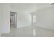 Open living area with tile floors, modern lighting, and easy access to other parts of the home at 19591 W Lincoln St, Buckeye, AZ 85326