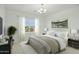 Staged main bedroom featuring natural light, modern decor, and king bed at 19591 W Lincoln St, Buckeye, AZ 85326