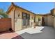 Back patio featuring red pavers and a covered area with access to the house at 19591 W Lincoln St, Buckeye, AZ 85326