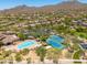 Community aerial view showing community pool, tennis courts, neighborhood and mountain views at 3518 N Shadow Trl, Mesa, AZ 85207