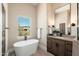 Stylish bathroom with a modern tub, wooden vanity, and sleek black fixtures at 3518 N Shadow Trl, Mesa, AZ 85207