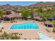 Community pool with lap lanes, lounge chairs and surrounding desert landscape at 3518 N Shadow Trl, Mesa, AZ 85207