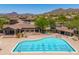 Relaxing pool area with desert and mountain views and community buildings at 3518 N Shadow Trl, Mesa, AZ 85207