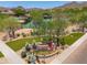 Scenic aerial view of the community featuring landscaping, pool, tennis courts and desert mountain views at 3518 N Shadow Trl, Mesa, AZ 85207