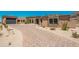 Beautiful home exterior featuring a stone facade, desert landscaping, and a long driveway at 3518 N Shadow Trl, Mesa, AZ 85207