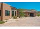 Exterior of a custom home featuring desert landscaping, a stone facade and a circular driveway at 3518 N Shadow Trl, Mesa, AZ 85207