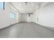 Spacious and bright garage featuring white walls, ample lighting, and smooth gray flooring at 3518 N Shadow Trl, Mesa, AZ 85207