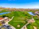 Aerial view of the lush green golf course and surrounding desert landscape and mountains at 3518 N Shadow Trl, Mesa, AZ 85207