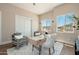 Well-lit home office with mountain views, modern desk, and comfortable gray seating at 3518 N Shadow Trl, Mesa, AZ 85207