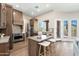 Modern kitchen featuring stainless appliances, a center island with bar seating, and plenty of storage at 3518 N Shadow Trl, Mesa, AZ 85207
