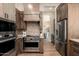Gourmet kitchen with stainless steel appliances and custom wood cabinetry and large island at 3518 N Shadow Trl, Mesa, AZ 85207