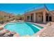 Luxury backyard with a pristine blue swimming pool, deck, and desert mountain views at 3518 N Shadow Trl, Mesa, AZ 85207