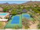 Aerial view of the community tennis courts, pool and lush desert landscape at 3518 N Shadow Trl, Mesa, AZ 85207