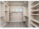 Spacious walk-in closet with ample shelving and soft, neutral carpeting at 3518 N Shadow Trl, Mesa, AZ 85207