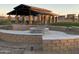 Landscaped fire pit area with brick seating at 1184 E Gleneagle Dr, Chandler, AZ 85249