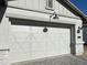 White garage door with X-design and black exterior lights at 1184 E Gleneagle Dr, Chandler, AZ 85249