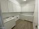 Laundry room with white cabinets and flooring at 1184 E Gleneagle Dr, Chandler, AZ 85249