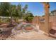 A gorgeous backyard fire pit with a built in grill, and tiled seating, perfect for outdoor dining and relaxation at 15115 W Cottonwood St, Surprise, AZ 85374