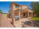 Outdoor kitchen with built-in barbecue and a fire pit for entertainment, surrounded by rock and artificial grass at 15115 W Cottonwood St, Surprise, AZ 85374
