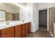 Double vanity bathroom with walk-in shower and closet access at 15115 W Cottonwood St, Surprise, AZ 85374