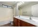 Bathroom featuring double sinks, tile floors, and a shower-tub combo with bright vanity lights at 15115 W Cottonwood St, Surprise, AZ 85374