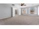 Large bedroom with carpeted floors, ceiling fan, and bright windows at 15115 W Cottonwood St, Surprise, AZ 85374