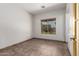 Cozy bedroom with tile floors, natural light through a window, and neutral walls at 15115 W Cottonwood St, Surprise, AZ 85374