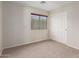 Empty bedroom featuring carpeted floors, closet, and natural light at 15115 W Cottonwood St, Surprise, AZ 85374