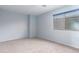 This bedroom features carpeted floors, blue walls, and bright windows at 15115 W Cottonwood St, Surprise, AZ 85374