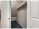 Slanted storage space featuring dark blue floors, white walls, and a long wooden rod at 15115 W Cottonwood St, Surprise, AZ 85374