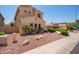 Side view of a stucco home featuring desert landscaping and a tile roof at 15115 W Cottonwood St, Surprise, AZ 85374