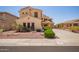 Two-story home with desert landscaping, solar panels, and a two-car garage at 15115 W Cottonwood St, Surprise, AZ 85374