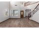 Open foyer featuring tile flooring, a decorative front door, and a staircase at 15115 W Cottonwood St, Surprise, AZ 85374
