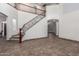 Large foyer with tile floors and an elegant staircase with decorative wrought iron at 15115 W Cottonwood St, Surprise, AZ 85374