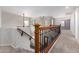 Upstairs hallway with decorative railing, carpeted floors and view of the stairs at 15115 W Cottonwood St, Surprise, AZ 85374