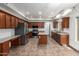 Updated kitchen with stainless steel appliances, granite counters, and dark wood cabinetry at 15115 W Cottonwood St, Surprise, AZ 85374