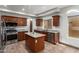 Updated kitchen featuring stainless steel appliances, a center island, and granite countertops at 15115 W Cottonwood St, Surprise, AZ 85374