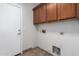 Laundry area with overhead cabinets and tile floors at 15115 W Cottonwood St, Surprise, AZ 85374