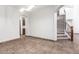 Bright living room with tile floors, staircase and views into the kitchen create an airy, connected living space at 15115 W Cottonwood St, Surprise, AZ 85374