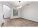 Inviting living room with large tile floors, a modern light fixture, and natural light from the window at 15115 W Cottonwood St, Surprise, AZ 85374