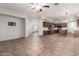 Expansive living area featuring a large tile floors and seamless transition to the kitchen at 15115 W Cottonwood St, Surprise, AZ 85374