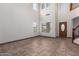 Spacious living room with tile flooring, soaring ceilings, and lots of natural light at 15115 W Cottonwood St, Surprise, AZ 85374