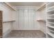 Walk-in closet featuring built-in shelving and ample storage space at 15115 W Cottonwood St, Surprise, AZ 85374