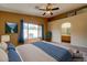 Comfortable bedroom with adjacent bathroom and large window at 3128 E Millbrae Ln, Gilbert, AZ 85234