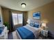 Cozy bedroom with window and neutral decor at 3128 E Millbrae Ln, Gilbert, AZ 85234