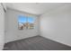 Bright bedroom with neutral carpet and a large window offering neighborhood views at 4106 W Eli Dr, San Tan Valley, AZ 85144