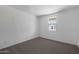 Neutral bedroom with wall-to-wall carpeting and a bright window offers natural light at 4106 W Eli Dr, San Tan Valley, AZ 85144