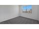 A well-lit bedroom featuring a large window providing natural light and neutral carpet at 4106 W Eli Dr, San Tan Valley, AZ 85144