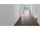 Bright hallway with wood-look flooring leading to a room with sliding glass doors at 4106 W Eli Dr, San Tan Valley, AZ 85144
