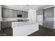 Modern kitchen with stainless appliances, an island, granite counters, and gray cabinetry at 4106 W Eli Dr, San Tan Valley, AZ 85144